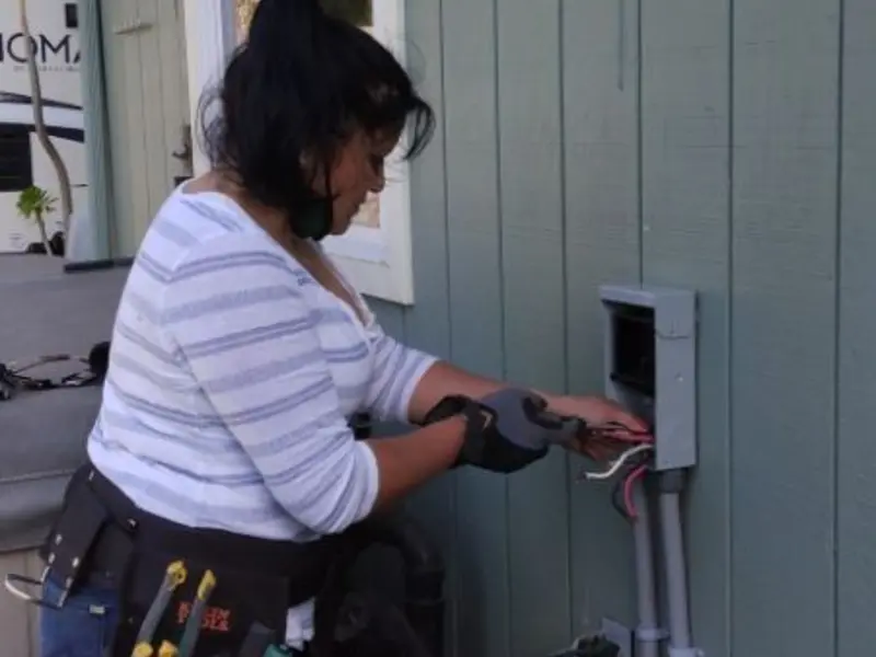 Licensed electrician wiring an exterior subpanel in Foster City